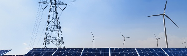solar panels and wind turbines against blue sky