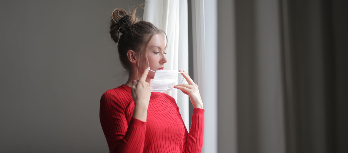 Woman holding face mask
