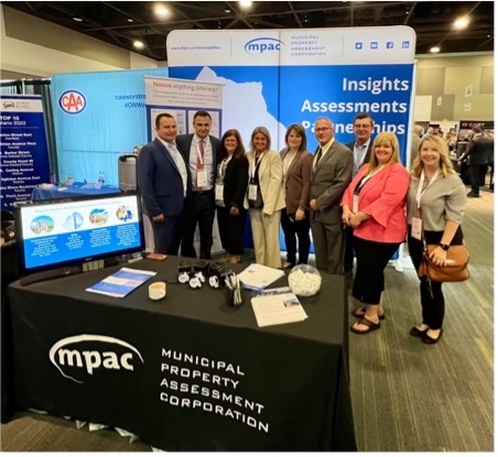MPAC staff at AMO 2022, standing beside our exhibitor booth