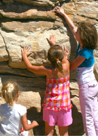 Children explore fossils at Dinosaur Ridge.
