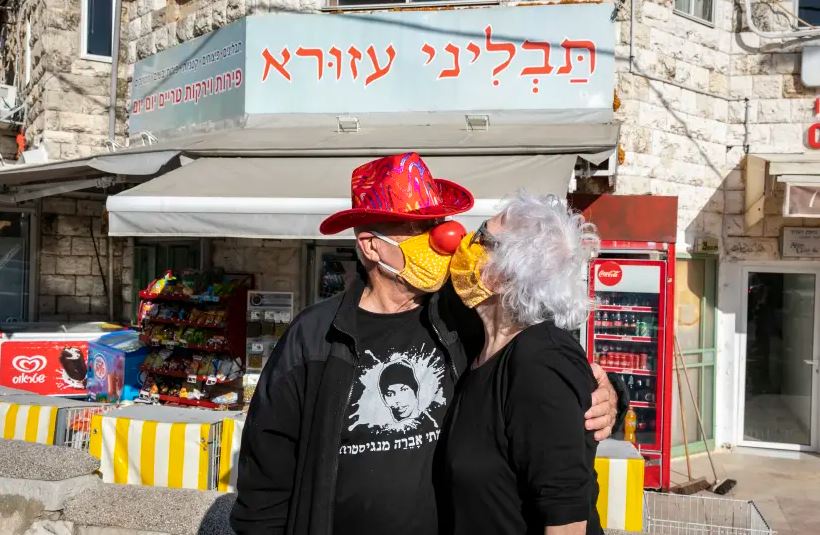 Couple kissing with masks