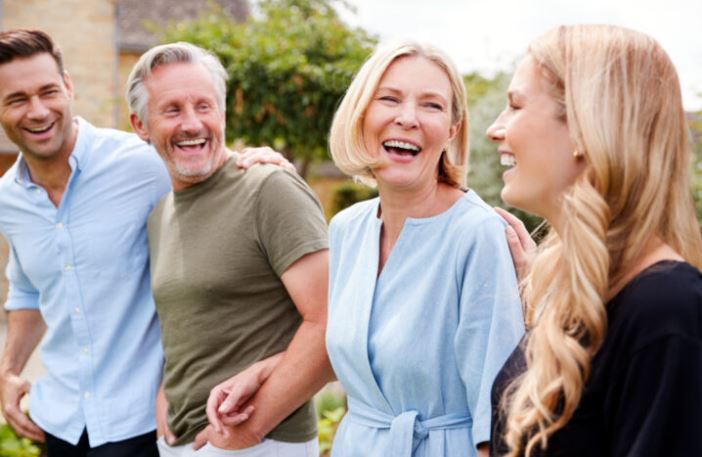 A son, father, mother, and daughter laughing